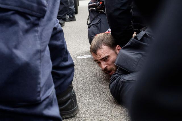 Police arrest an anti-immigration demonstrator during a protest in the city of Portsmouth, southern England on September 12, 2026. Hundreds of anti-immigration protesters and counter-demonstrators faced off on September 12 in the southern English city of Portsmouth, at closely-watched duelling rallies which authorities fear could descend into unrest after violent scenes there on September 6. (Photo by Brook Mitchell / AFP)