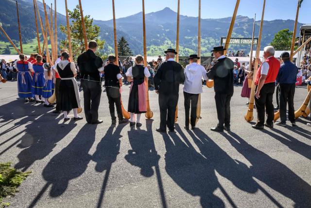 Alphorn players stand during the first edition of the Federal Youth Yodeling Festival, in the Alpine resort of Grindelwald, Switzerland, on September 12, 2026. Grindelwald is hosting the first-ever Federal Youth Yodeling Festival, bringing together young talents aged 5 to 25 from across Switzerland to celebrate yodeling, alphorn and Buchel playing, as well as flag throwing. (Photo by Fabrice COFFRINI / AFP)