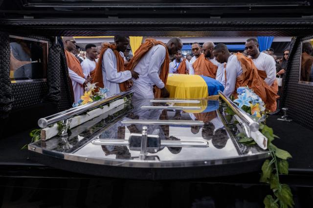 The casket containing the remains of the late Ugandan King Oyo Nyimba Kabamba Iguru Rukidi IV being carried by royal guards onto a funeral van after the church service, ahead of a procession to Karambi Royal Tombs for burial in Fort Portal, Uganda, on September 12, 2026. King Oyo, who ascended to the throne at the age of three and reigned over Uganda's Tooro Kingdom for 31 years, died while receiving cancer treatment in the United States.
Guinness World Records had recognised him as the world's youngest reigning monarch. Uganda is a republic but officially recognises traditional kings, who serve mainly as cultural institutions with limited political power. (Photo by Badru KATUMBA / AFP)