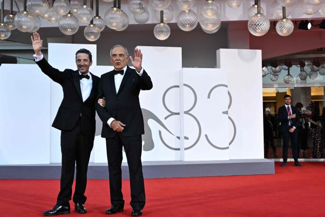President of Venice Film Festival Pietrangelo Buttafuocco (L) and Italian director of the Venice International Film Festival Alberto Barbera wave on the red carpet of the closing ceremony of the 83rd Venice Film Festival at Venice Lido on September 12, 2026 (Photo by Tiziana FABI / AFP)