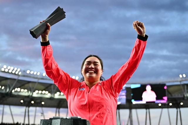 Winner Japan's Haruka Kitaguchi celebrates with the trophy after her victory in the women's javelin throw final during the World rates on the podium with the trophy after winningAthletics Ultimate Championship at the Gyula Zsivotzky National Athletics Centre, in Budapest on September 12, 2026. (Photo by Ben STANSALL / AFP)