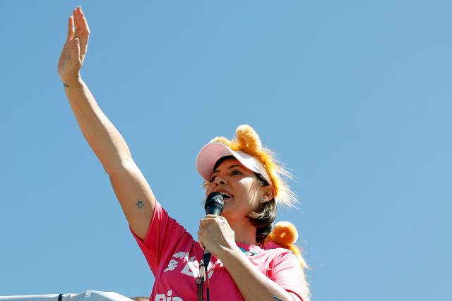 Brazil's former First Lady and candidate for the Federal Senate for the Liberal Party (PL), Michelle Bolsonaro, waves during a motorcade in Ceilandia, an administrative region of Brasilia's Federal District, on September 12, 2026. Michelle Bolsonaro backs her stepson, Flavio Bolsonaro, for the upcoming October 4 presidential election. (Photo by Sergio Lima / AFP)