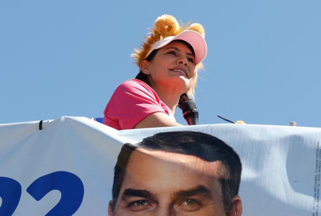 Brazil's former First Lady and candidate for the Federal Senate for the Liberal Party (PL), Michelle Bolsonaro, gestures during a motorcade in Ceilandia, an administrative region of Brasilia's Federal District, on September 12, 2026. Michelle Bolsonaro backs her stepson, Flavio Bolsonaro, for the upcoming October 4 presidential election. (Photo by Sergio Lima / AFP)