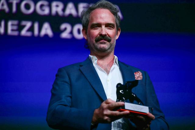 Peter Flaherty receives the Venice Immersive Best Director Award for "Empire at sea" during the closing ceremony of the 63rd Venice Film Festival at Venice Lido on September 12, 2026. (Photo by Stefano Rellandini / AFP)