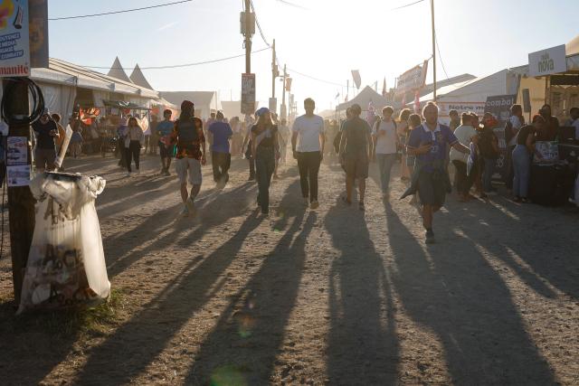 Revellers walk during the annual "Fete de l'Humanite" festival organised by French left wing newspaper L'Humanite, in Le Plessis-Pate, south of Paris, on September 12, 2026. (Photo by GEOFFROY VAN DER HASSELT / AFP)