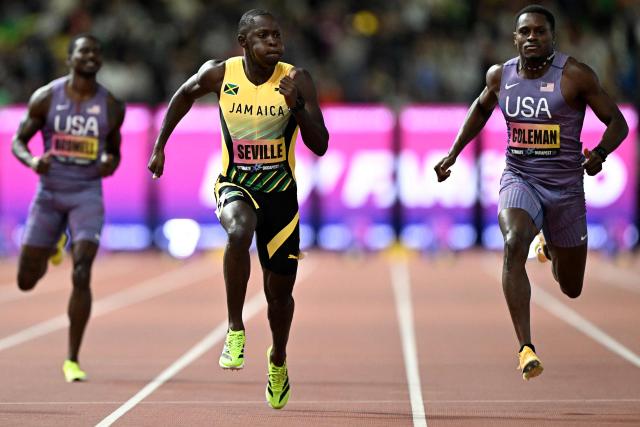 Jamaica's Oblique Seville (C) and US' Christian Coleman (R) compete in the men's 100m semi-final heat 1 during the World Athletics Ultimate Championship at the Gyula Zsivotzky National Athletics Centre, in Budapest on September 12, 2026. (Photo by Jewel SAMAD / AFP)