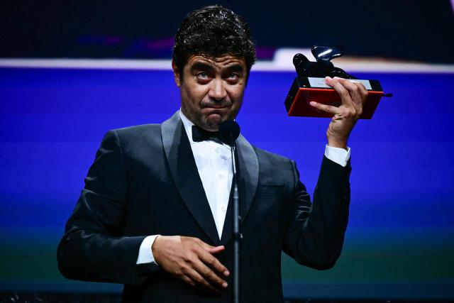 Italian actor Riccardo Scamarcio receives the Orizzonti Award for Best Actor for his part in "I fligli della scimmia" (The children of the monkey) during the closing ceremony of the 63rd Venice Film Festival at Venice Lido on September 12, 2026. (Photo by Stefano Rellandini / AFP)