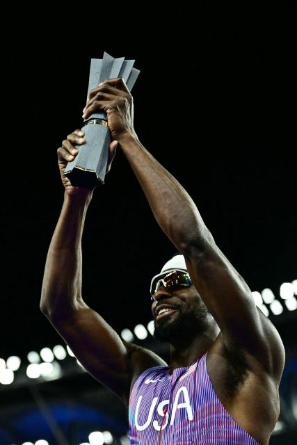 Winner US' Kenneth Bednarek celebrates with the trophy after his victory in the men's 100m final during the World Athletics Ultimate Championship at the Gyula Zsivotzky National Athletics Centre, in Budapest on September 12, 2026. (Photo by Ben STANSALL / AFP)