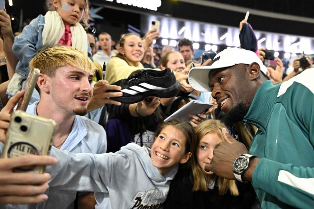 Former Jamaican athlete Usain Bolt poses for selfies with fans during the World Athletics Ultimate Championship at the Gyula Zsivotzky National Athletics Centre, in Budapest on September 12, 2026. (Photo by Jewel SAMAD / AFP)