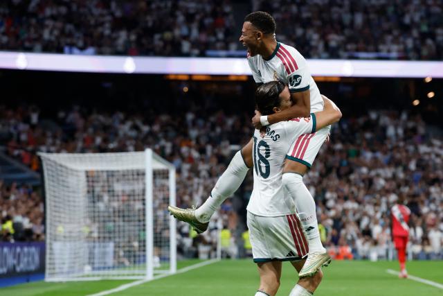Real Madrid's Spanish defender #18 Alvaro Fernandez Carreras  (L) celebrates with Real Madrid's French forward #10 Kylian Mbappe after scoring his team's second goal during the Spanish league football match between Real Madrid CF and Rayo Vallecano de Madrid at Santiago Bernabeu Stadium in Madrid on September 12, 2026. (Photo by Oscar DEL POZO / AFP)
