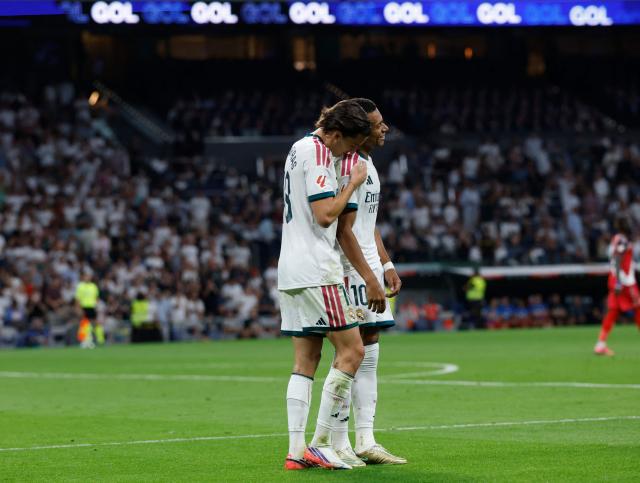 Real Madrid's Spanish defender #18 Alvaro Fernandez Carreras  (L) celebrates with Real Madrid's French forward #10 Kylian Mbappe after scoring his team's second goal during the Spanish league football match between Real Madrid CF and Rayo Vallecano de Madrid at Santiago Bernabeu Stadium in Madrid on September 12, 2026. (Photo by Oscar DEL POZO / AFP)