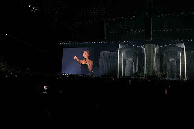 Canadian singer Celine Dion appears on a giant screen as she performs during her first concert of a series at the Plenitude Arena in Nanterre, west of Paris on september 12, 2026. Celine Dion is to fulfil her dream of returning to the stage after years battling a rare neurological disorder, with thousands of fans from all over the world descending on the arena west of Paris. (Photo by Thomas SAMSON / AFP)