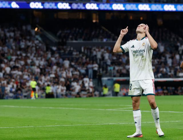 Real Madrid's Spanish defender #18 Alvaro Fernandez Carreras celebrates scoring his team's second goal during the Spanish league football match between Real Madrid CF and Rayo Vallecano de Madrid at Santiago Bernabeu Stadium in Madrid on September 12, 2026. (Photo by Oscar DEL POZO / AFP)