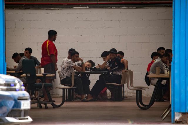 Migrants rest inside Tarajal warehouses, used by authorities as a temporary migrant reception facility (CATE), in Ceuta on September 12, 2026. More than 70,000 migrants streamed into Ceuta from neighbouring Morocco on July 30 and 31, in an unprecedented rush that left scores dead. Thousands remain in the small city, increasing tensions with increasingly frustrated locals who demand their expulsion and a return to normality. The crisis has generated a constant churn of negative headlines and dominated the political debate for six weeks. (Photo by Antonio Sempere / AFP)