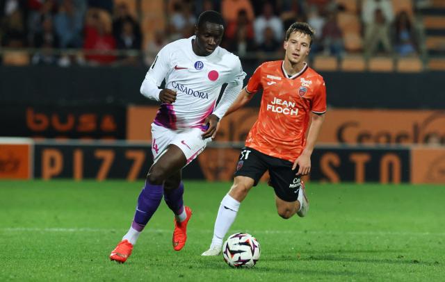 Lorient's French midfielder #11 Theo Le Bris fights for the ball with Toulouse's French-Senegalese defender #94 Ismail Diall during the French L1 football match between FC Lorient and Toulouse FC at the Stade du Moustoir in Lorient, western France, on September 12, 2026. (Photo by Fred TANNEAU / AFP)