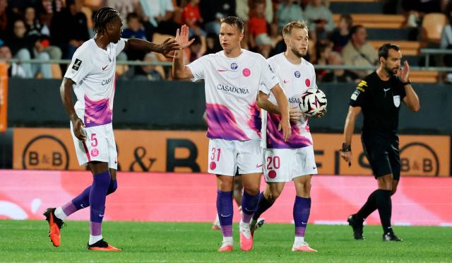 oulouse's German midfielder #31 Niklas Schmidt (C) and Toulouse's French defender #05 Seny Koumbassa (L) celebrate after their team scored a goal during the French L1 football match between FC Lorient and Toulouse FC at the Stade du Moustoir in Lorient, western France, on September 12, 2026. (Photo by Fred TANNEAU / AFP)