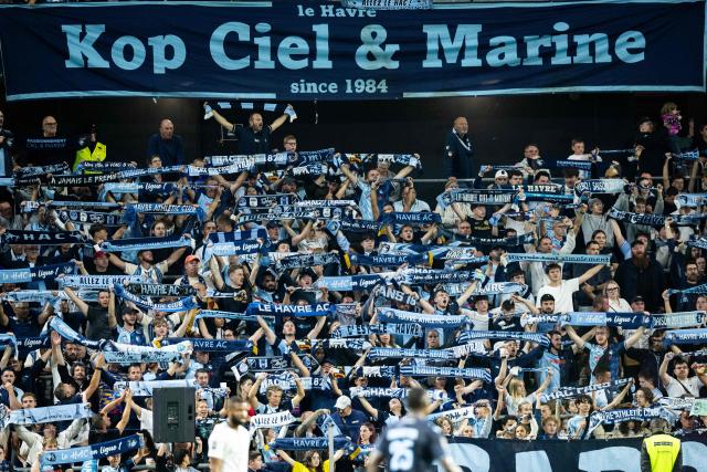 Supporters of Le Havre's supporters group "Kop Ciel & Marine" hold up scarves during the French L1 football match between Le Havre AC and SCO Angers at the Stade Oceane in Le Havre, northwestern France, on September 12, 2026. (Photo by Guillaume SALIGOT / AFP)