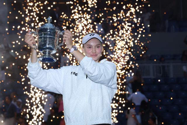 Kazakhstan's Elena Rybakina holds the winner's trophy after winning the women's singles final tennis match against Belarus's Aryna Sabalenka on day fourteen of the US Open tennis tournament at the USTA Billie Jean King National Tennis Center in New York City on September 12, 2026. (Photo by TIMOTHY A. CLARY / AFP)