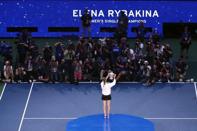 Kazakhstan's Elena Rybakina holds up the trophy after winning the women's singles final tennis match against Belarus's Aryna Sabalenka on day fourteen of the US Open tennis tournament at the USTA Billie Jean King National Tennis Center in New York City on September 12, 2026. (Photo by Leonardo MUNOZ / AFP)