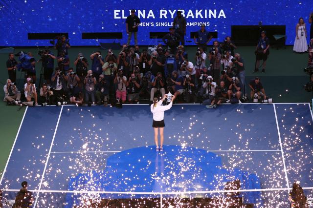 Kazakhstan's Elena Rybakina holds up the trophy after winning the women's singles final tennis match against Belarus's Aryna Sabalenka on day fourteen of the US Open tennis tournament at the USTA Billie Jean King National Tennis Center in New York City on September 12, 2026. (Photo by Leonardo MUNOZ / AFP)