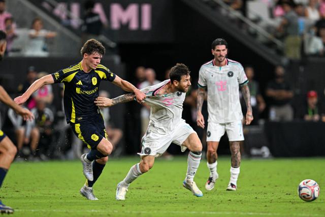 Inter Miami's Argentine forward #10 Lionel Messi is grabbed by his jersey while fighting for the ball with Nashville's US midfielder #16 Matthew Corcoran during a Major League Soccer (MLS) regular season football match between Inter Miami CF and Nashville FC at Nu Stadium in Miami, Florida, on September 12, 2026. (Photo by CHANDAN KHANNA / AFP)