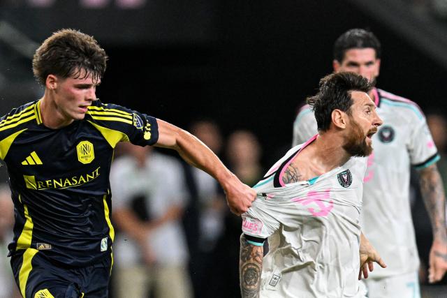 Inter Miami's Argentine forward #10 Lionel Messi is grabbed by his jersey by Nashville's US midfielder #16 Matthew Corcoran (L) during a Major League Soccer (MLS) regular season football match between Inter Miami CF and Nashville FC at Nu Stadium in Miami, Florida, on September 12, 2026. (Photo by CHANDAN KHANNA / AFP)