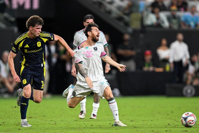 Inter Miami's Argentine forward #10 Lionel Messi is grabbed by his jersey by Nashville's US midfielder #16 Matthew Corcoran during a Major League Soccer (MLS) regular season football match between Inter Miami CF and Nashville FC at Nu Stadium in Miami, Florida, on September 12, 2026. (Photo by CHANDAN KHANNA / AFP)