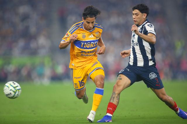Tigres' midfielder #16 Diego Lainez and Monterrey's defender #03 Gerardo Arteaga fight for the ball during the Liga MX Apertura tournament football match between Monterrey and Tigres, at the BBVA Stadium in Guadalupe, state of Nuevo Leon, Mexico, on September 12, 2026. (Photo by Julio Cesar AGUILAR / AFP)
