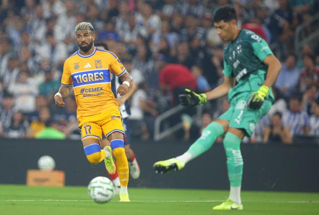Tigres’ Uruguayan forward #17 Rodrigo Aguirre and Monterrey's Argentine goalkeeper #01 Esteban Andrada fight for the ball during the Liga MX Apertura tournament football match between Monterrey and Tigres, at the BBVA Stadium in Guadalupe, state of Nuevo Leon, Mexico, on September 12, 2026. (Photo by Julio Cesar AGUILAR / AFP)