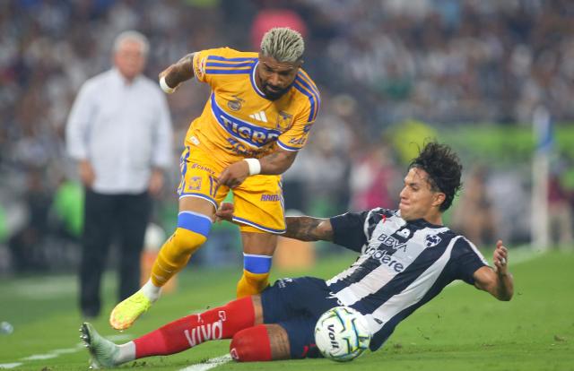 Tigres’ Uruguayan forward #17 Rodrigo Aguirre and Monterrey's defender #13 Carlos Salcedo fight for the ball during the Liga MX Apertura tournament football match between Monterrey and Tigres, at the BBVA Stadium in Guadalupe, state of Nuevo Leon, Mexico, on September 12, 2026. (Photo by Julio Cesar AGUILAR / AFP)