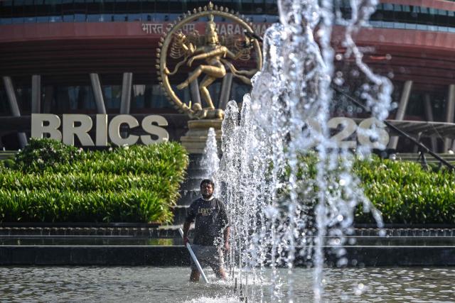 A woker cleans fountains in the complex of Bharat Mandapam during the 18th BRICS Summit in New Delhi on September 13, 2026. (Photo by Arun SANKAR / AFP)