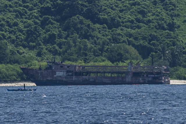 The burnt-out wreckage of a ferry that caught fire is seen in Coron, Palawan on September 13, 2026. The death toll from a Philippine ferry fire jumped to 76 on September 12 after the coast guard confirmed the discovery of 41 more bodies aboard the burnt-out vessel. (Photo by Jam STA ROSA / AFP)