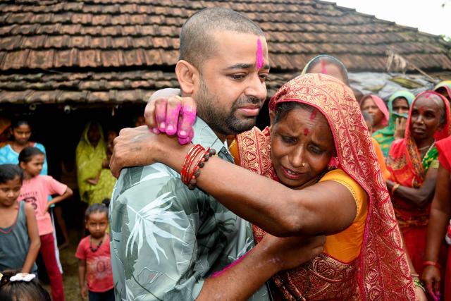 CORRECTION / Nepali hydropower worker Sanjay Sah (L) breaks down after meeting his mother at his residence in Nepal's Saptari district on September 13, 2026 after being rescued from a flooded tunnel in the aftermath of deadly flash floods. For 10 days, Nepali hydropower worker Sanjay Sah survived in darkness inside a flooded tunnel, drinking muddy water and losing all sense of time as he desperately prayed for rescue. (Photo by Deepesh Deo Joshi / AFP) / The erroneous mention[s] appearing in the metadata of this photo by Deepesh Deo Joshi has been modified in AFP systems in the following manner: [September 13] instead of [September 12]. Please immediately remove the erroneous mention[s] from all your online services and delete it (them) from your servers. If you have been authorized by AFP to distribute it (them) to third parties, please ensure that the same actions are carried out by them. Failure to promptly comply with these instructions will entail liability on your part for any continued or post notification usage. Therefore we thank you very much for all your attention and prompt action. We are sorry for the inconvenience this notification may cause and remain at your disposal for any further information you may require.