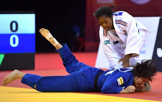 France’s Liz Ngelebeya (top, white) and Japan’s Mao Izumi compete in the women's under 78kg category bout at the Hungary Grand Slam judo tournament, part of the IJF World Judo Tour, in Budapest on September 13, 2026. (Photo by FERENC ISZA / AFP)