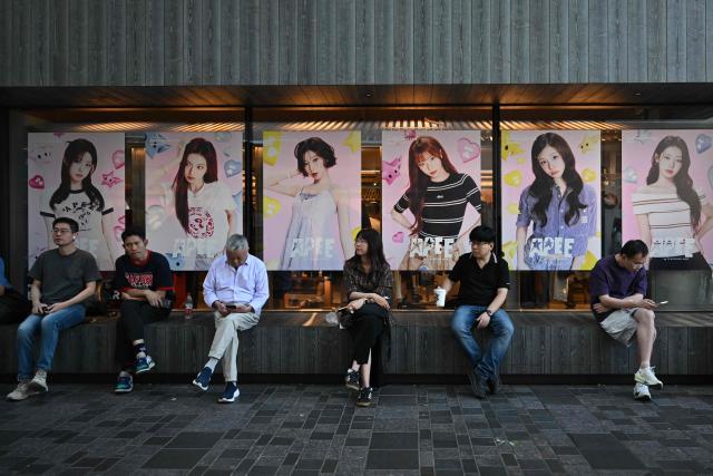 People visit a shopping mall in Beijing on September 13, 2026. (Photo by Pedro PARDO / AFP)