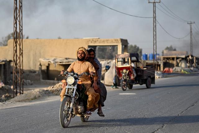 Afghan men ride a motorcycle along a street in the Dand district of Afghanistan's Kandahar province on September 13, 2026. (Photo by Sanaullah SEIAM / AFP)