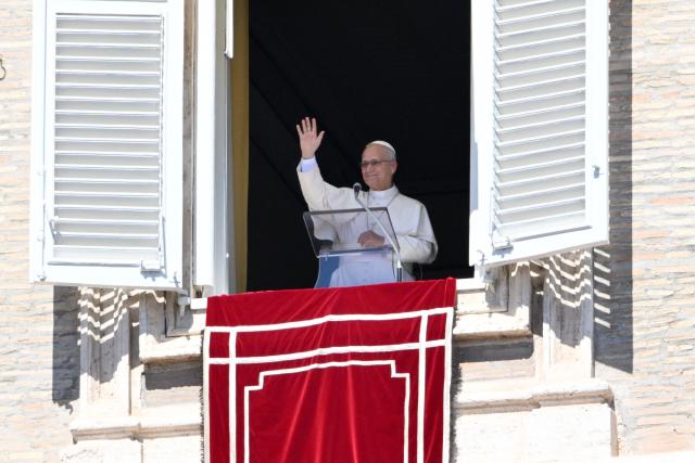 Pope Leo XIV waves to the crowd from the window of the apostolic palace overlooking St Peter's Square during his Sunday Angelus prayer at the Vatican on September 13, 2026 (Photo by Alberto PIZZOLI / AFP)