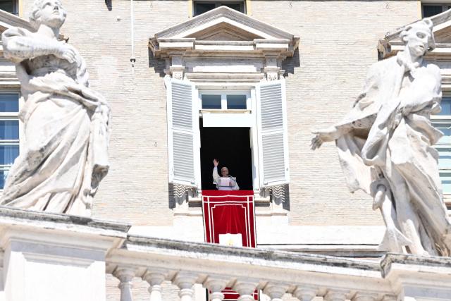 Pope Leo XIV waves to the crowd from the window of the apostolic palace overlooking St Peter's Square during his Sunday Angelus prayer at the Vatican on September 13, 2026 (Photo by Alberto PIZZOLI / AFP)