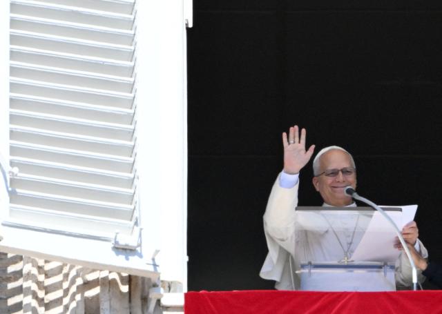 Pope Leo XIV waves to the crowd from the window of the apostolic palace overlooking St Peter's Square during his Sunday Angelus prayer at the Vatican on September 13, 2026 (Photo by Alberto PIZZOLI / AFP)