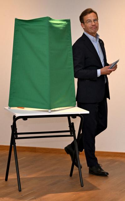 Sweden's Prime Minister Ulf Kristersson, leader of the conservative Moderates, prepares to cast his ballot at a polling station in Strangnas near Stockholm, during Sweden's general election on September 13, 2026. Polling stations opened on September 13, 2026 in Sweden in what is expected to be a close general election that will see either the far right enter government for the first time or the left-wing opposition reclaim power. (Photo by Jonathan Nackstrand / AFP)