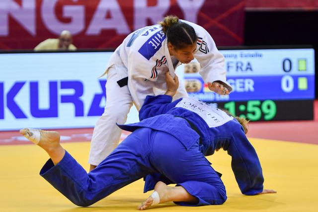 France’s Fanny Estelle Posvite (top, white) and Germany’s Lea Schmid compete in the women's under 78kg category bout at the Hungary Grand Slam judo tournament, part of the IJF World Judo Tour, in Budapest on September 13, 2026. (Photo by FERENC ISZA / AFP)