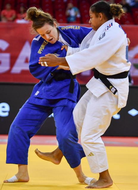 France’s Fanny Estelle Posvite (R, white) and Germany’s Lea Schmid compete in the women's under 78kg category bout at the Hungary Grand Slam judo tournament, part of the IJF World Judo Tour, in Budapest on September 13, 2026. (Photo by FERENC ISZA / AFP)