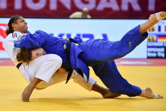 France’s Fanny Estelle Posvite (L, white) and Germany’s Lea Schmid compete in the women's under 78kg category bout at the Hungary Grand Slam judo tournament, part of the IJF World Judo Tour, in Budapest on September 13, 2026. (Photo by FERENC ISZA / AFP)