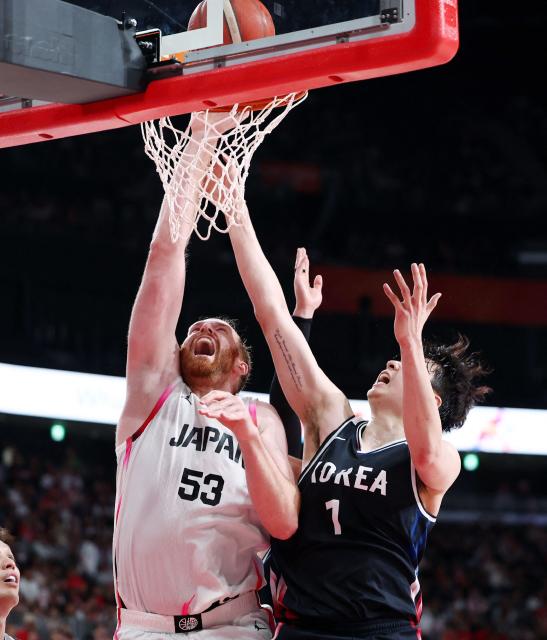 Japan's Alex Kirk is challenged by South Korea's Lee Hyun-jung during their 2026 Asian Games men's group A basketball game at Aichi International Arena in Nagoya on September 13, 2026. (Photo by JIJI Press / AFP) / Japan OUT