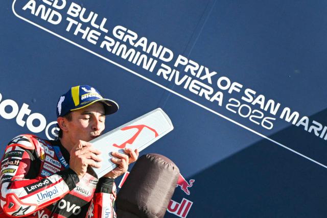 Ducati Lenovo Team's Spanish rider Marc Marquez kisses his trophy on the podium following his victory at the end of the San Marino Moto GP Grand Prix at the Misano World Circuit Marco Simoncelli, in Misano Adriatico, northern Italy on September 13, 2026. (Photo by Andreas SOLARO / AFP)