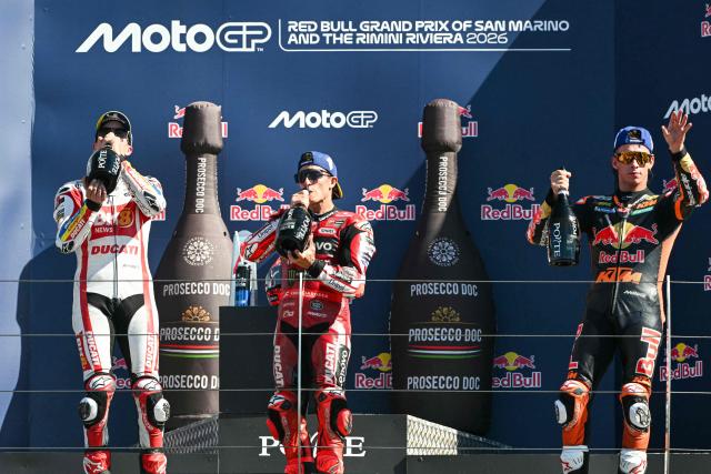 (FROM L) Second place BK8 Gresini Racing's Spanish rider Alex Marquez, first place Ducati Lenovo Team's Spanish rider Marc Marquez and third place Red Bull KTM Factory Racing's Spanish rider Pedro Acosta celebrate on the podium at the end of the San Marino Moto GP Grand Prix at the Misano World Circuit Marco Simoncelli, in Misano Adriatico, northern Italy on September 13, 2026. (Photo by Andreas SOLARO / AFP)
