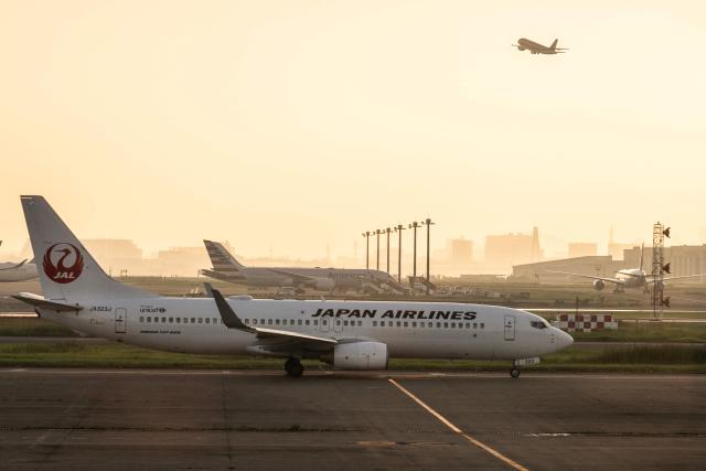 A Japan Airlines plane passes Terminal 1 at Haneda International Airport as it taxies to take off late in the day in Ota on September 13, 2026. (Photo by ANDREW CABALLERO-REYNOLDS / AFP)