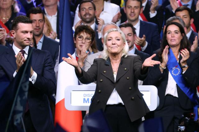 President of the far-right Rassemblement National (RN) parliamentary group and 2027 French presidential candidate Marine Le Pen (C) reacts flanked by RN President Jordan Bardella (L) at the end of a rally for the start of the new political year in Henin-Beaumont, northern France, on September 13, 2026. (Photo by Thomas SAMSON / AFP)
