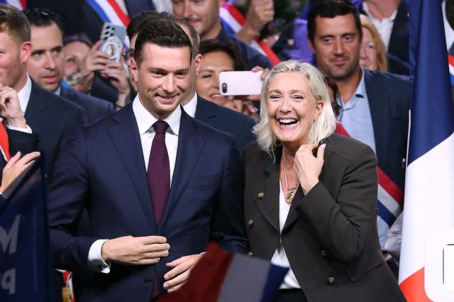President of the far-right Rassemblement National (RN) parliamentary group and 2027 French presidential candidate Marine Le Pen (R) and RN President Jordan Bardella (L) react on stage at the end of a rally for the start of the new political year in Henin-Beaumont, northern France, on September 13, 2026. (Photo by Thomas SAMSON / AFP)