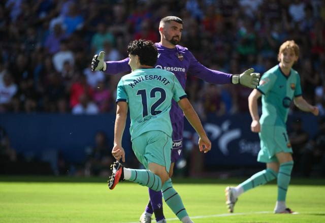 Barcelona's Spanish defender #12 Xavi Espart celebrates scoring his team's first goal during the Spanish league football match between Levante UD and FC Barcelona at Ciutat de Valencia Stadium in Valencia on September 13, 2026. (Photo by JOSE JORDAN / AFP)